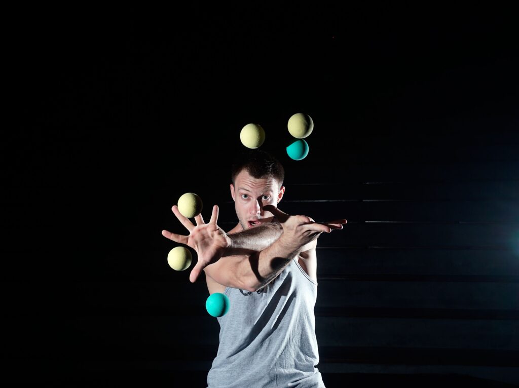 Man juggling too many balls at once, alluding to overloaded span of control